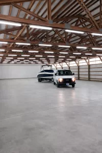 Seattle area warehouse valet boat storage service featuring indoor boat storage in a clean, well-lit facility with concrete floors and wood beam ceiling.